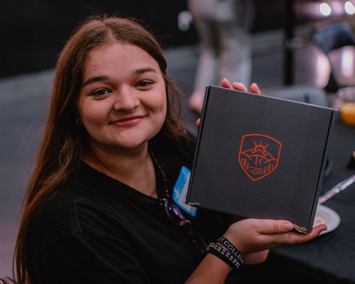 Student holding a Sun City College welcome box