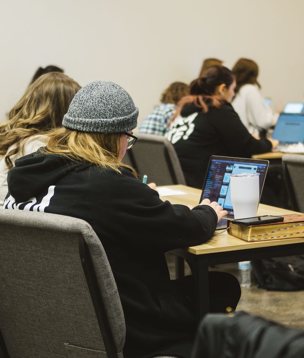 Student working on a laptop during class